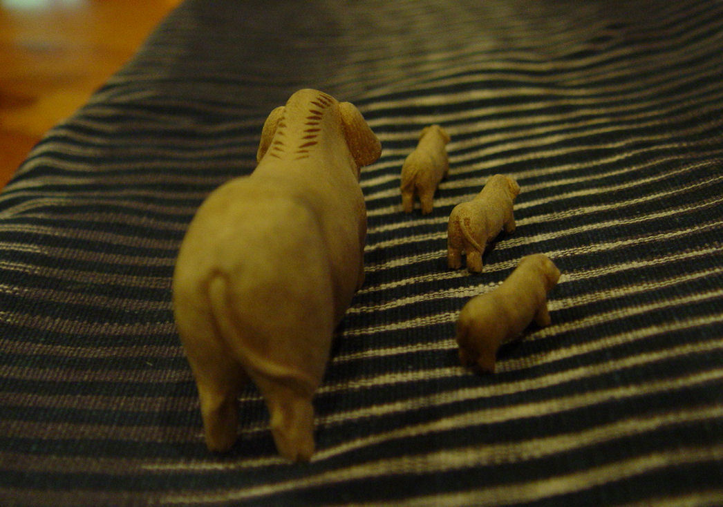 Hand carved,
                late 19th century, early 20th Mother pig and piglets